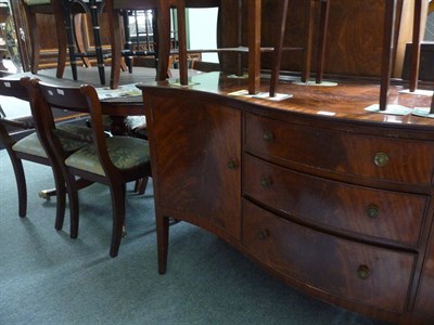 Lot 439 - A Regency style mahogany dining suite of a pedestal dining table, six chairs and a serpentine front