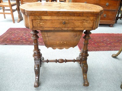 Lot 467 - A Victorian figured walnut sewing table