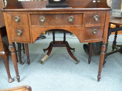 Lot 479 - A Georgian mahogany small bow front sideboard