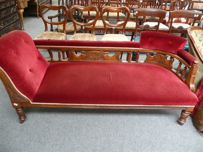 Lot 496 - A late Victorian walnut chaise longue upholstered in crimson velour