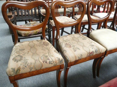 Lot 497 - Three mahogany balloon-back chairs on sabre legs