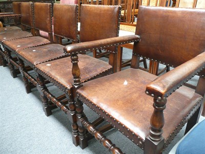 Lot 501 - Set of six oak studded leather dining chairs including two carvers