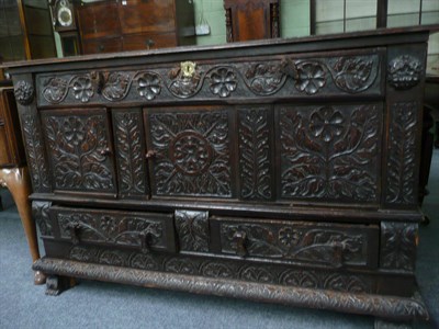 Lot 563 - A carved oak mule chest