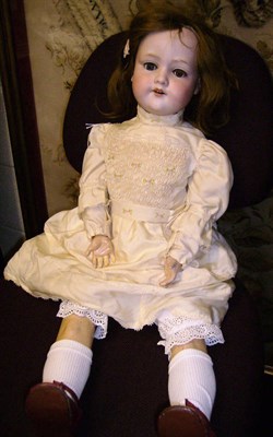 Lot 1008 - Armand Marseille 390n Bisque Socket Head Doll with sleeping blue eyes, auburn wig, on a composition