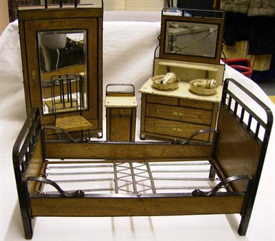 Lot 1015 - A Bavarian Oak And Metal Dolls Bedroom Suite and two dolls enamelled wash sets.