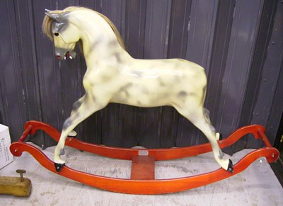 Lot 1017 - A Haddon Rockers Dapple Grey Wooden Rocking Horse on a bow rocker, 145cms length, 107cms high.