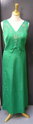 Lot 1086 - Circa 1960's Full Length Green Satinised Evening Dress with beaded decoration; Gina Bacconi...