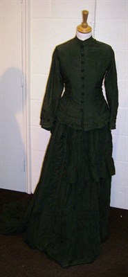 Lot 1088 - A Victorian Green Silk Two Piece Wedding Dress with fitted long sleeved jacket and full skirt...