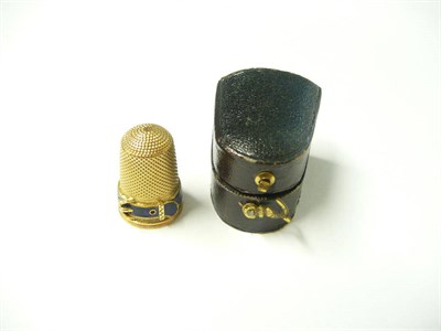 Lot 1141 - An Enamelled Thimble, the base of the thimble enamelled in dark blue, in the form of a belt and...