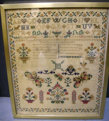 Lot 1155 - Framed Needlework Sampler 'The Ten Commandments' worked in silk cross stitch, depicting the...