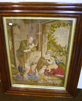 Lot 1168 - Large Rosewood Framed Berlin Woolwork Tapestry depicting figures seated in a door way playing...