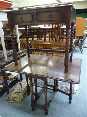 Lot 1239 - An oak side table with two frieze drawers on barley twist legs; an oak gateleg table (2)