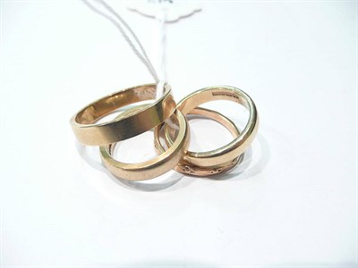 Lot 13 - Three 9 carat gold band rings and another