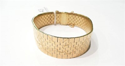 Lot 43 - An 18 carat gold textured cuff bracelet