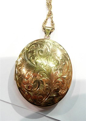 Lot 181 - A 9 carat gold oval engraved locket on a chain