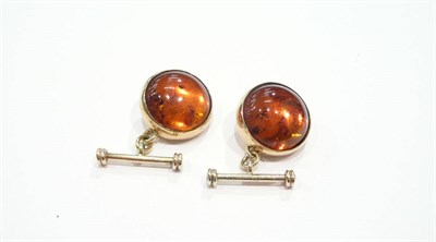 Lot 195 - A pair of amber and gold cufflink's