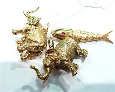 Lot 196 - Two 9 carat gold elephant charms and a 9 carat gold fish charm