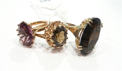 Lot 210 - A 9 carat gold amethyst ring, a 9 carat gold smokey  quartz ring and another