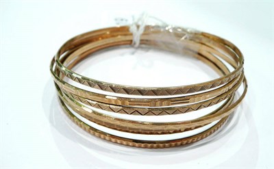 Lot 219 - Six 9 carat gold patterned bangles (6)