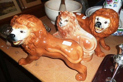 Lot 340 - Pair of lions and a recumbent lion