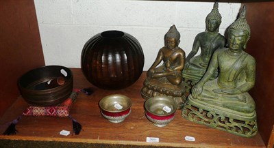 Lot 393 - A 'Singing' bowl on a cushion, a fluted vase, a pair of metal-mounted bowls and three Buddhas