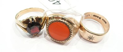 Lot 409 - A nine carat gold garnet ring, a nine carat gold diamond set signet ring and a cornelian ring