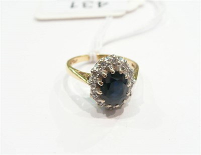 Lot 431 - An 18 carat gold sapphire and diamond cluster ring