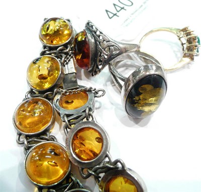 Lot 440 - 9 carat band ring, 9 carat dress ring, two amber rings and an amber bracelet