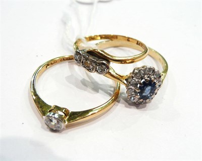 Lot 453 - 18 carat gold sapphire and diamond cluster ring, diamond solitaire ring and a diamond three...