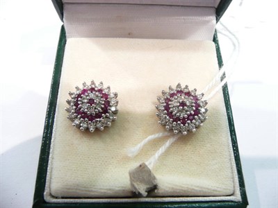 Lot 458 - A pair of ruby and diamond cluster stud earrings