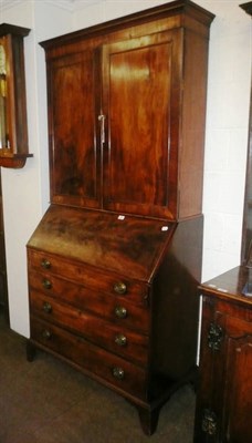 Lot 556 - A George III mahogany bureau bookcase, with moulded cornice above two flame mahogany  panel...