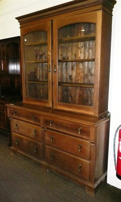 Lot 560 - An oak glazed bookcase over a sideboard base