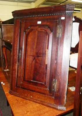 Lot 573 - An 18th century oak hanging corner cupboard