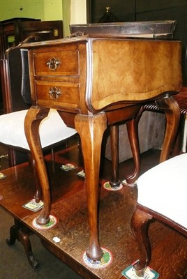 Lot 587 - A walnut drop-leaf table fitted two drawers and a cupboard