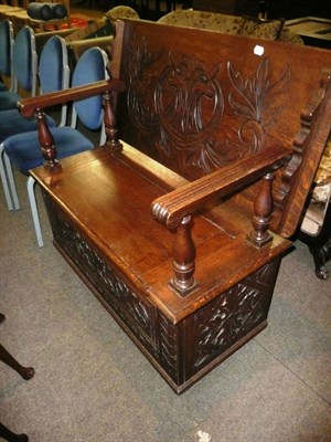 Lot 629 - Carved oak monks bench