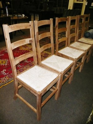 Lot 651 - Set of six modern oak ladder back chairs with rush seats