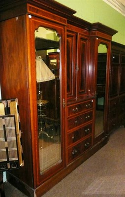 Lot 700 - An Edwardian mahogany satinwood banded inverted breakfront wardrobe