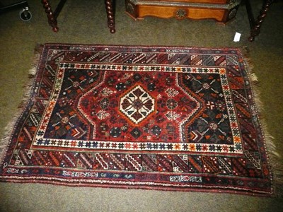 Lot 719 - Kashgai rug, South West Persia, the madder field with stepped ivory medallion