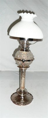 Lot 46 - A silver plated oil lamp with cut glass reservoir and shade