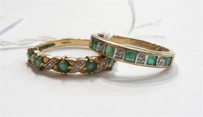 Lot 72 - Two emerald and diamond half eternity rings