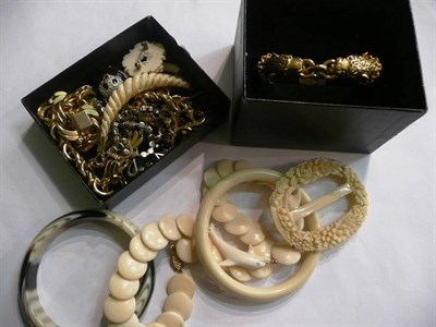 Lot 101 - Two bone necklaces, a buckle, a brooch, a bangle, a horn bangle, two pendants, a panda brooch,...