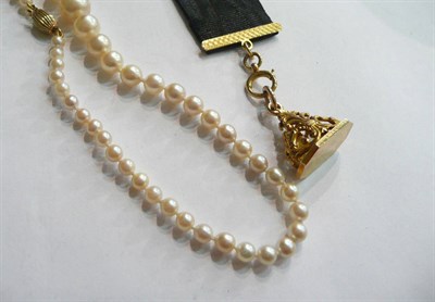 Lot 102 - A 9 carat gold fob on a fabric suspension, and a strand of graduated cultured pearls