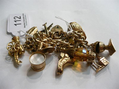 Lot 112 - A curb and lock bracelet hung with thirteen charms