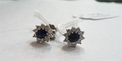 Lot 114 - A pair of sapphire and diamond cluster earrings