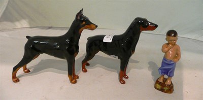 Lot 122 - A Royal Worcester "Burmah" figure, and a Royal Doulton dog and a Beswick dog (3)