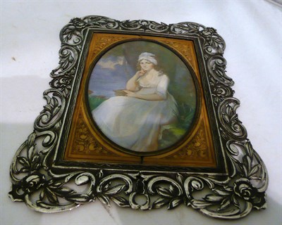 Lot 136 - W Petrie - miniature of a lady seated by a lake, French 19th century in a white metal scroll frame