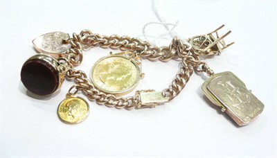 Lot 226 - A 9 carat gold charm bracelet hung with six charms including a loose-mounted 1963 sovereign