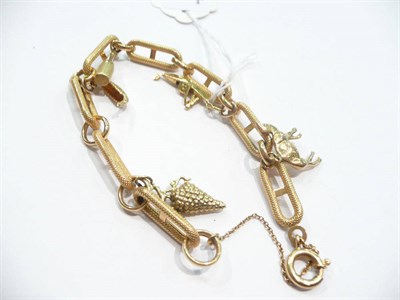 Lot 268 - A fancy link bracelet stamped '750' hung with five charms