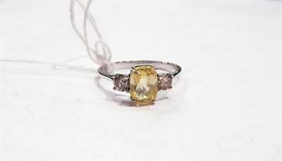 Lot 274 - A 14 carat white gold yellow sapphire and diamond ring