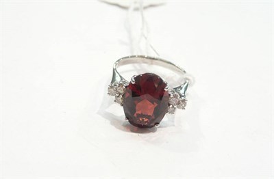 Lot 275 - A 14 carat white gold garnet and diamond ring